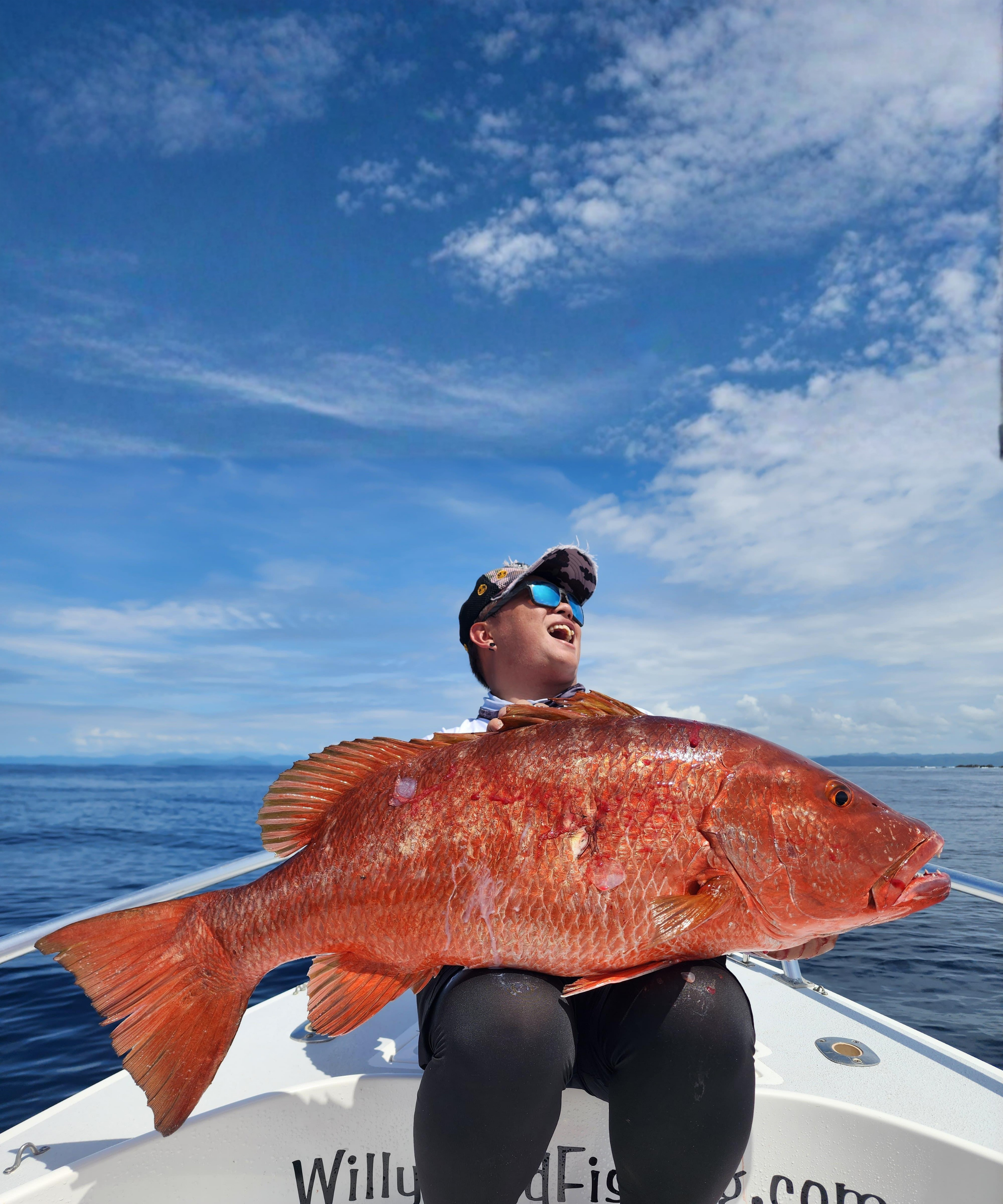 PPFA angler holding a large red snapper at sea